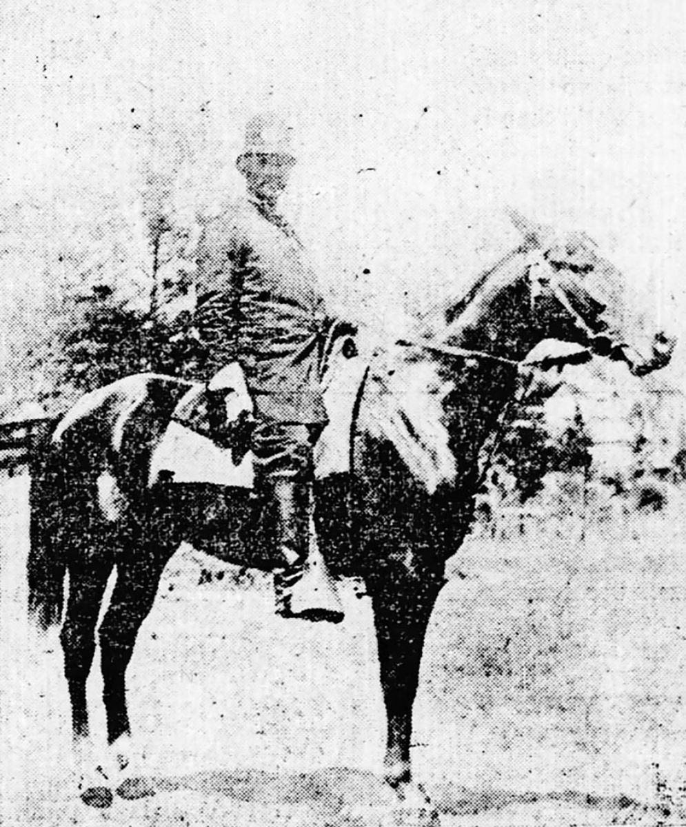 West in policeman's uniform posing on a horse