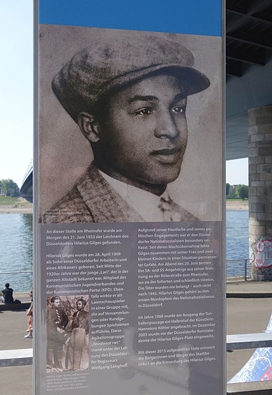 1) Hilarius Gilges Plaque Stands on The Rhine River in Dusseldorf (Wikipedia)