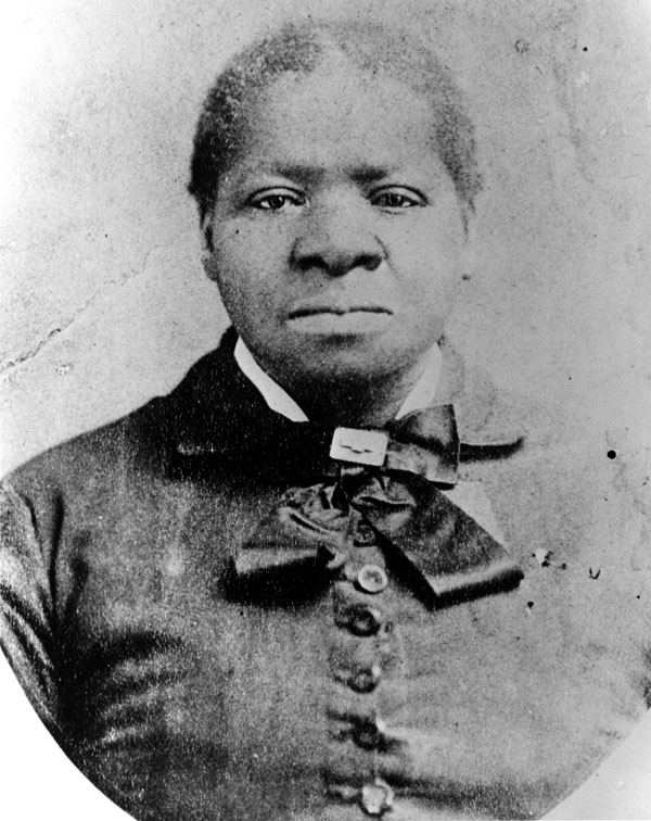 Black and white portrait of Biddy with buttoned dress and ribbon around neck. Her hair is pulled back.|Bridget Biddy Mason| |