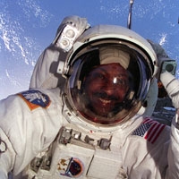 Scott_Winston|Scott_Winston selfie of Winston Scott wearing a space suit with Earth behind him|