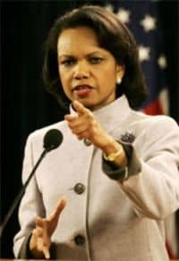  Condoleeza Rice standing at a microphone pointing towards the audience