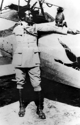 Black and white photo of Eugene Jacques Bullard standing in front of a small plane