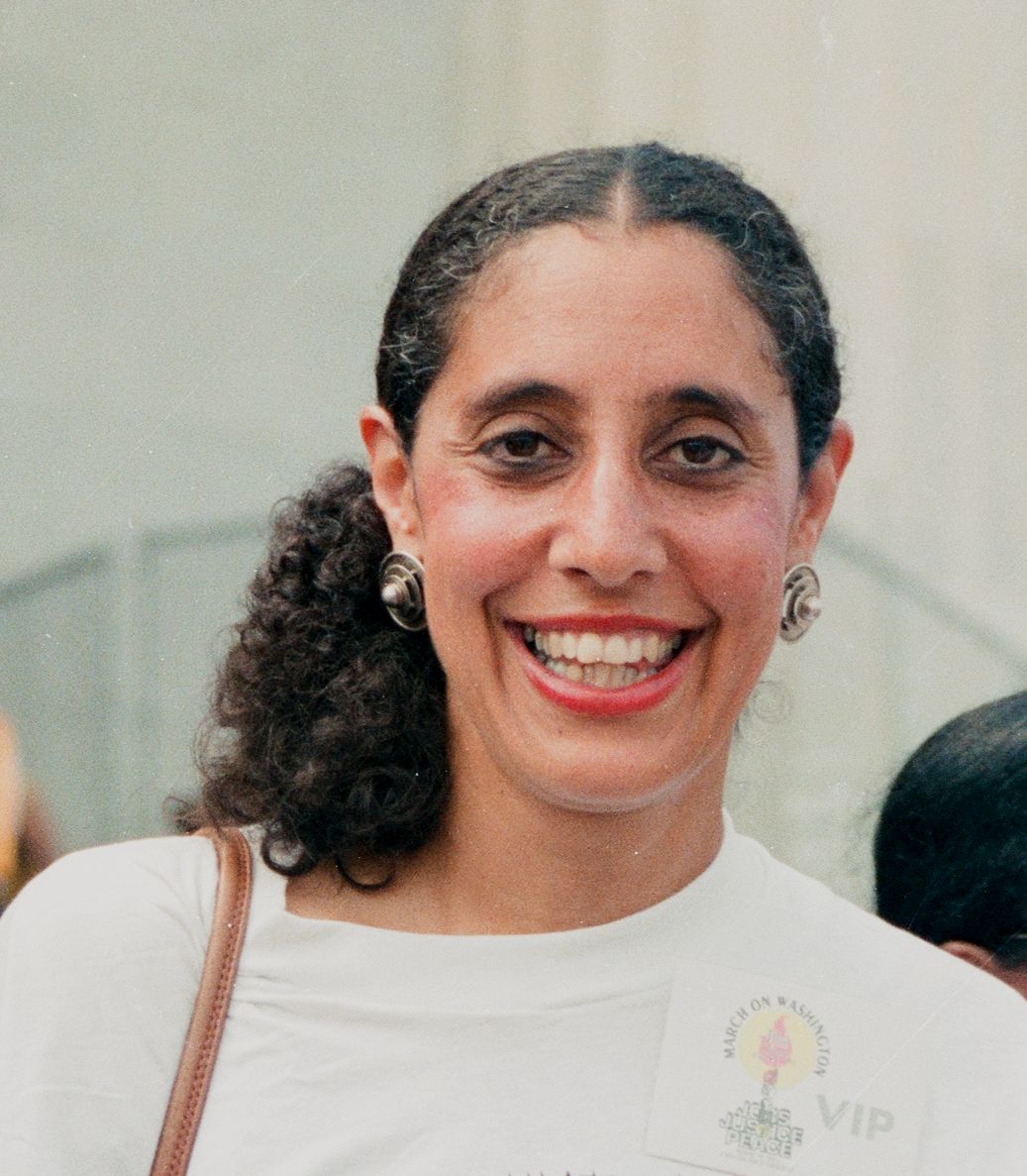 Guinier smiling, wearing a March on Washington card on shoulder