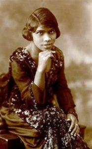 Faded black and white photo of Marian Anderson sitting and looking at the camera