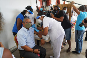 Ramkalawan receives vaccine by nurses wearing face masks and members of the press